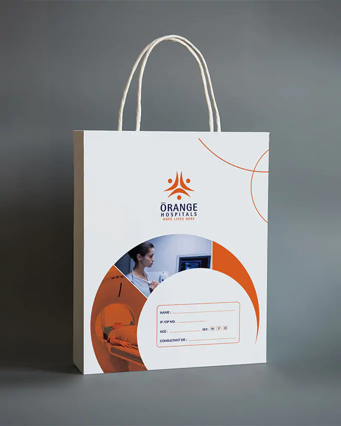 A white medical file bag designed for Orange Hospitals, featuring the hospital logo, curved orange accents, and a patient information section on the front with images of diagnostic care.